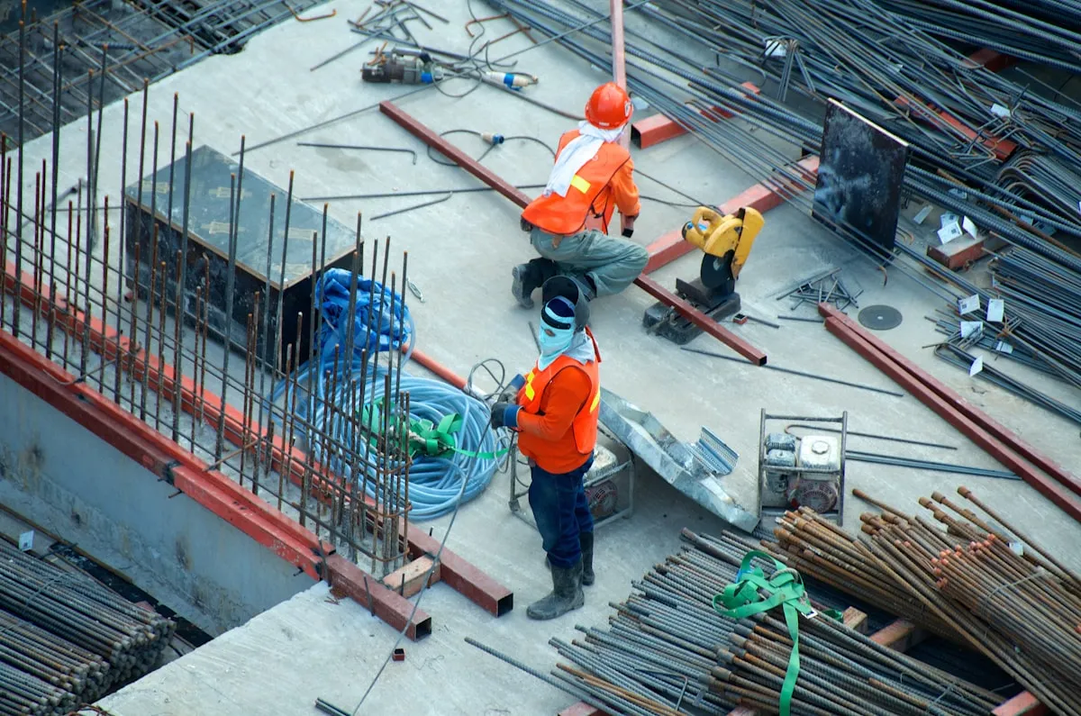 Professional London tradesperson reviewing a business website on a laptop at a worksite