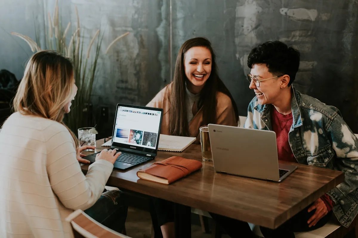Small business owners collaborating over a laptop during a web design consultation in London