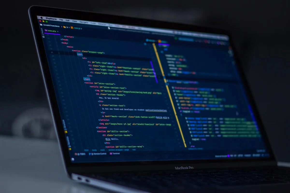 Developer writing clean code for a web application in a London studio.